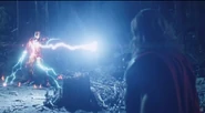 Thor striking Iron Man with his hammer.
