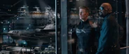 Steve Rogers and Nick Fury standing in front of a helicarrier under construction.