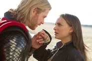 Thor kisses Jane Foster's hand.