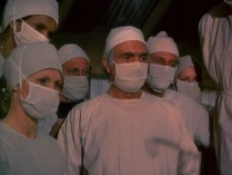 Closeup-surgery-the consultant.jpg (30 KB) A close up view of Borelli and others watching the arterial graft operation. The nurse to the left of Borelli looks very familiar. Trapper's mystery nurse could be the one at the back, right of Henry.