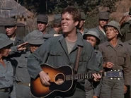 The so-called visit by MacArthur is a let-down. Spalding sings while the MASH personnel disperse.