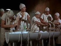 The doctors scrubbing prior to operating. The nurse to the extreme right is probably Marcia Gelman. Behind is a blonde nurse who might be Sheila Lauritsen.