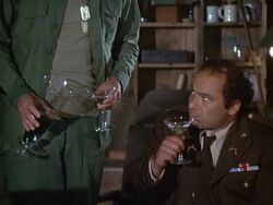 Willis begins the interview with a round of drinks. His First Lieutenant's bar (dull silver) can just be seen on his shoulders. This shot also shows a good view of his medals ribbons. Someone can have fun identifying them.