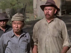 Richard Lee Sung (right) has a speaking part but is uncredited in this episode.