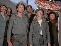 The large crowds gathering to watch 5 O'Clock Charlie are ideal for identifying extras. See Kellye Nakahara at Margaret's left, holding an umbrella. Seems like Jeff Maxwell is behind.