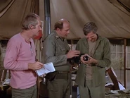 Turnbull gives Klinger a bottle of Chateau Margaux in exchange for two cases of fruit cocktail. Klinger gives it to Hawkeye but it takes Winchester to show him the true value of this vintage wine.