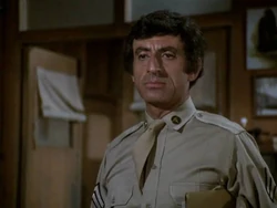 Klinger in a rare moment smartly dressed - the medical corps insignia for enlisted men is clearly seen on his left lapel.