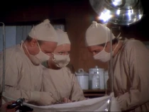 We only see Watson in a mask in "Hot Lips and Empty Arms". She is helping Frank and Hawkeye with a patient.