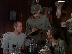 Earlier in the same episode, Carmine can be seen in the background behind Burns. He is on the ladder cleaning the light.