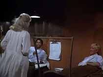 Welch on the right, Latimer on the left. Welch is telling Margaret that Kwang's tree-bark brew works and he wants more.