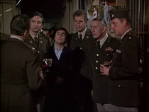 The MASH personnel debate whether enlisted men such as Mitchell's son (center) should be admitted to the Officers Club. They finally accept Hawkeye's creative suggestion to allow relatives - well the whole MASH is family!