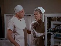 The only time we see Margaret in her white nurse uniform. This is a flashback in the mind of General Hammond to the time years back when they were at Fort Benning.