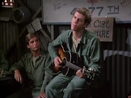 Spalding echoes the mood of the men in the Officers Club with a melancholy rendition of "I Wonder If They Miss Us".