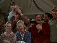 In this scene from Bottoms Up, Laurie is the one seated in a blue dressing gown. Next to her is Nurse Jo Ann.