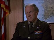 Colonel Carmichael presides at Hawkeye's hearing in "The Novocaine Mutiny". Besides the Eighth Army sleeve patch, the insignia on his lapels show that he is an officer of the Adjutant-General's Corps.