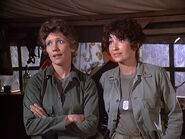 Baker (left) with Lieutenant Campbell in Season 6 "Patent 4077". Her wedding ring can just be seen on her left hand.