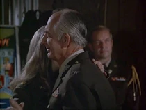 General Mitchell seems to enjoy himself, spending the night slow dancing with Margaret, watched by his aide Captain Fox.