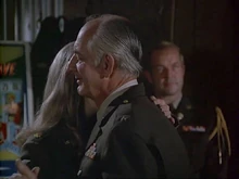 Fox is in the background watching Mitchell dance with Margaret. This is the only time we see Fox in his full dress uniform with the aiguillettes of a General's aide-de-camp. Scene from "Officers Only".