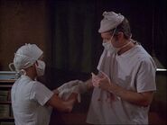 Gwen Farrell's Able assists BJ in the OR in "Dear Ma".