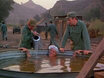 Henry in a makeshift pool in the camp compound.