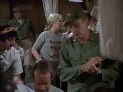 Another view of Carmine from the same episode, right at the back. He has left the room and has come in again.