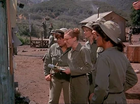 Nurses at the bulletin board studying the volleyball fixtures. Besides Simmons, there is Kellye and Gwen. Two unknowns are behind Simmons.