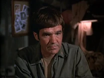 Jack Riley as Kaplan. His Captain's bars (in black) can just be seen on his right lapel.