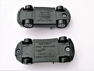 Tesla Model S, Hot Wheels and Matchbox comparison. Hot Wheels bottom, Matchbox top. Underside view.