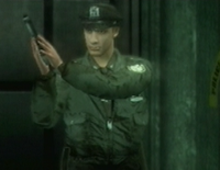 A police officer coming out of an elevator.