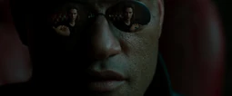 Morpheus' offer, a red pill and a blue pill, seen through his sunglasses