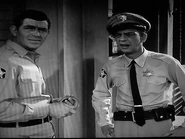 Barney spots Fred sweeping into the street