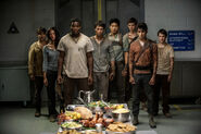 Tim, Teresa, Frypan, Thomas, Minho, Newt, Winston and Jack looking at food.