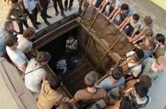 Newt staring down at Teresa lying asleep in the Box