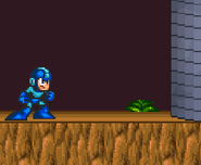Mega Man standing in front of a building on the stage.