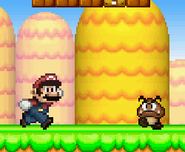 Mario running near a Goomba.