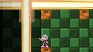 Bomberman taunting, giving a victory sign.