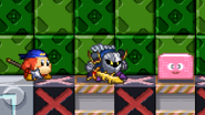Kirby using Stone next to Meta Knight and Bandana Dee on Bomb Factory.