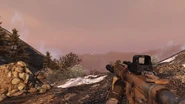 M4A1 with a vertical front grip and holographic sight.