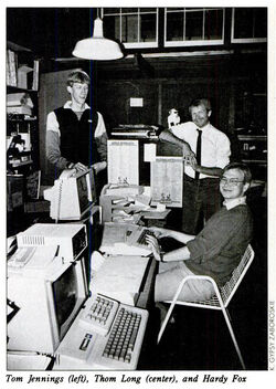  at an Apple II computer, with Tom Jennings and Thom Long