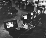 Bridgit Terris watching TV at the bus terminal, ca. 1979