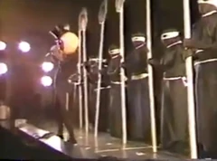 A Resident sings the closing lyrics to ""; the  cut-outs from the  tour were unavailable, so the group had to quickly create replacements for the show