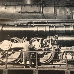 An  clad figure working on a steam engine; from the artwork for the 2003 release 