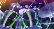 Take-Mikazuchi seen playing the drums of Persona 4: Dancing All Night