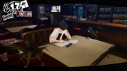 The protagonist studying at Cafe Leblanc.