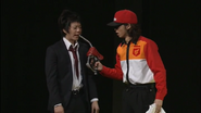 The attendant holding up a gas nozzle to Adachi’s face