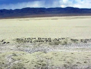 "All Your Base Are Belong to Us" graffitied on the side of U.S. Route 50 in Nevada.