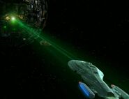 USS Voyager caught in the tractor beam of a Borg sphere