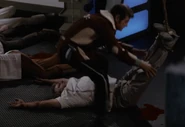 McCoy assisting in laying his corpse on the floor