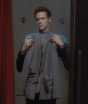 Bashir holding up a suit jacket