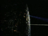 Borg cube sending out a tractor and cutting beam